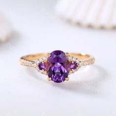 Unique amethyst engagement ring,6x8mm oval shaped amethyst ring,Moissanite band,Vintage amethyst wedding ring,Anniversary gift for her Main Ring Metal Type: 10k/14k/18k solid rose/white/yellow gold Bottom Band Width:1.2mm Center Stone: 6X8mm oval shaped amethyst Side Stone:2mm round cut amethyst+ 0.15ct moissanites This ring can be matched with other wedding band. See the matching band please visit: https://www.etsy.com/shop/PENNIjewel?ref=listing-shop2-all-items-count%C2%A7ion_id&section_id Exquisite Oval Amethyst Ring For Wedding, Exquisite Oval Amethyst Wedding Ring, Oval Brilliant Cut Amethyst Ring For Wedding, Elegant Oval Amethyst Promise Ring, Exquisite Oval Amethyst Ring For Anniversary, Exquisite Amethyst Ring For Wedding, Dainty Oval Amethyst Wedding Ring, Amethyst Wedding Ring, Amethyst Wedding Rings