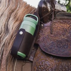 a close up of a horse's saddle with a cell phone attached to it