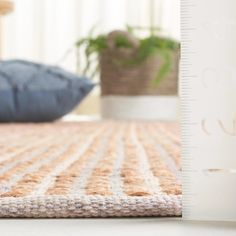 a close up view of a rug with a ruler on the floor next to it