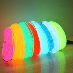 neon colored cords are lined up on the floor