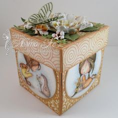 a decorative box with flowers and pictures on it