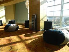 an empty room with large windows and bean bag chairs on the floor in front of them