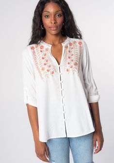 Looking for a Spring wardrobe refresh? This simple yet refined long sleeve bohemian blouse features a delicate self-covered button front, flattering split v-neckline, and floral embroidered detail. Wear it loose over denim, or try it tied in the front. Vintage floral embroidery Relaxed fit Long rolled sleeve with button tab closure Rounded hemline Side vents V-neckline Lace trim Self-covered button front Can be tied at the front Bohemian top Model is 5'9, wearing a size S.Style: I-13797W-RPX Feminine Embroidered V-neck Blouse, White Henley Neckline Top For Spring, Summer Henley Neckline Blouse With Buttons, Spring Long Sleeve Rayon Peasant Top, Spring Floral Embroidered Tunic Blouse, Bohemian Embroidered Button-up Tops, Bohemian Blouse With Button Closure For Vacation, Floral Embroidered V-neck Peasant Top For Spring, Spring Rayon Tunic Blouse