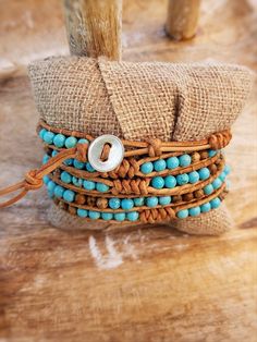 Chic boho wrap bracelet with Bright Turquoise colored beads mixed with Picture Jasper with decorative snake knot accents. Threaded onto natural color raw tan leather. Wraps around the wrist 5 times total. Bracelets are approximately 37 inches in length total and adjustable between 34-36 inches due to several loop closu Adjustable Turquoise Bohemian Wrap Bracelet, Adjustable Bohemian Turquoise Wrap Bracelet, Adjustable Southwestern Hand Wrapped Jewelry, Southwestern Adjustable Hand Wrapped Jewelry, Southwestern Hand Wrapped Adjustable Jewelry, Adjustable Southwestern Style Hand Wrapped Jewelry, Adjustable Hand Wrapped Leather Wrap Bracelet, Earthy Adjustable Hand Wrapped Bracelet, Adjustable Earthy Hand Wrapped Bracelet