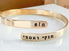 Are you looking for a special piece of jewelry to commemorate a terrific lady? Celebrate the resilience and love of a marvelous woman with this personalized wraparound bangle bracelet.  With a fashionable, sleek wraparound style in brass, sterling silver, 14K gold-filled, or 14K rose gold-filled, this meaningful design is available in a variety of metals. Complete this look with two names or phrases of your choice - each up to seven characters in length - inscribed in a tiny English and Hebrew font. You can choose to have the words in black or no black. ➤FEATURES Adjustable - just slip on like a bangle bracelet and give a gentle squeeze  4.5-5mm wide Choose your wrist size and I will make the bracelet the proper length ➤Choose Metal 1. Gold filled - beautiful 14K gold filled.  2. Rose gold Hebrew Phrases, Meaningful Design, Twisted Bangle, Judaica Gifts, Hard Metal, Black Features, Name Jewelry, Gift For Wife, Stunning Jewellery