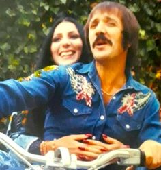 a man and woman on a motorcycle posing for a photo