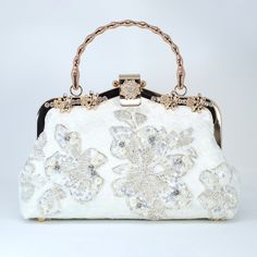 New to our Millennium collection, This beautiful romantic WHITE Embroidered FLORAL bridal clutch bag is made of very fine quality of fabric and metal and it comes with a two long Detachable chain one is pearl chain and other is metal chain of your choice for your Big day! Dimensions- length oh the bag is 9 inches and Height of the bag is 6 inches and 3 inches wide. Pearl chain measure about 43 inches and Gold Metal chain about 47 inches long. ► ABOUT YOUR ORDER * All items are neatly packaged in our beautiful jewelry boxes and elegant organza bags. * All items are 100% gift-ready. * Each order comes with a personalized handwritten card and a branded Millennium Bride jewelry cloth. * Each order comes with a free gift. ► PERSONALIZTION * If your order is a gift, you may contact us with the r White Top Handle Evening Bag For Formal Events, Elegant Top Handle Shoulder Bag For Wedding, Silver Evening Bag With Detachable Handle For Wedding, Elegant Cream Bag For Ceremonies, White Top Handle Evening Bag, Wedding Shoulder Bag With Detachable Top Handle, White Rectangular Evening Bag For Wedding, Gold Top Handle Shoulder Bag For Wedding, White Rectangular Evening Bags