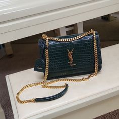 Comes Shipped With: Original Box, Ribbon, Wrapping, Dust Bag, And Sealed Ysl Papers. Ysl Medium Green Purse In Embossed Crocodile Leather Magnetic Snap Closure. Bag With Front Flap, Featuring Gold Side Gussets, Chain, And Leather/Metal Shoulder Strap. Strap Can Be Worn Crossbody Or Shortened On The Shoulder. Features A Leather-Encased Key Ring And The Logo In Gold. Final Sale, No Returns No Exchanges. Please Look At Photos To Confirm Condition Before Purchase. Dimensions 8.6 X 6.2 X 2.3 Inches Strap Doubled 11 Inches Strap Long 20 Inches Interior: Two Main Compartments, One Flat Pocket, One Gussetted Open Pocket At The Front. Suede Lining. One Flat Pocket At The Back Exterior 1 Ysl Green Bag, Ysl Sunset Bag Green, Green Ysl Clutch, Ysl Black Envelope Bag, Ysl Envelope Chain Wallet Black, Green Purse, Yves Saint Laurent Bags, Crocodile Leather, Calf Skin