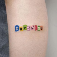 the word paradise written in small letters on a woman's thigh with colored crayons