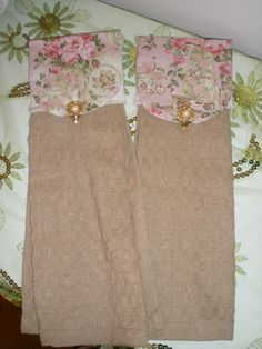 two brown and pink bedspreads laying on top of a flowered bed spread