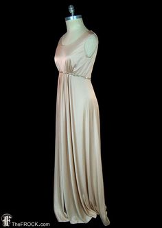 "BIG NEWS After 22 years, our website, TheFROCK.com, has had a makeover. Check out the new site, and join our mailing list for new arrivals.  Vintage Halston sleeveless satin-finished jersey goddess gown with center gathered waist and glass beaded waistband. Hidden rear zipper. Bust 36\", waist 28\", length 59\".  Condition is excellent.  Layaway is available. ALL DELIVERY DATES mentioned by Etsy are ESTIMATES, no delivery date or range is guaranteed, though most of our orders arrive ahead of es Elegant Beige Maxi Dress With Empire Waist, Elegant Beige Empire Waist Maxi Dress, Stretch Beige Maxi Dress For Evening, Vintage Halston, Tan Skin Tone, Goddess Gown, Knit Gown, Beaded Maxi Dress, Gown Vintage