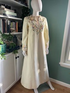 Absolutely beautiful long tunic dress with pretty floral embroidery at neckline and sleeves washed and ready to wear! Would make a fantastic boho wedding dress Fully lined  Back zipper closure fully functional  Overall the dress is in good vintage condition for its age. The embroidery is in excellent shape and completely intact. There is some staining here and there that didn't come out in the wash. The bottom 2.5 inches at the hem has several light marks. There are a few light stains on what wo Bohemian Embroidered Maxi Dress For Wedding, Bohemian Floral Embroidered Dress For Wedding, Bohemian Embroidered Maxi Wedding Dress, Traditional Cream Dress For Spring, Traditional Cream Dresses For Spring, Folk Style Wedding Dress For Eid, Long Sleeve Dress With Embroidered Neckline For Wedding, Spring Wedding Dress With Intricate Embroidery, Spring Wedding Dress With Embroidered Hem