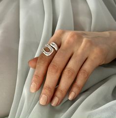 a woman's hand with a ring on it