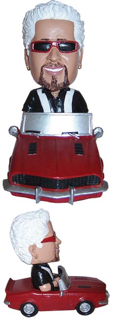 two bobble heads are sitting on top of a red car and one is wearing sunglasses