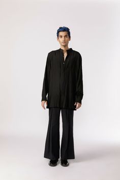 Long-line button-down shirt crafted from black chanderi, featuring box pleats throughout, long sleeves, and a mandarin collar. Fit: Comfort fitColor: BlackFabric: Cotton Chanderi