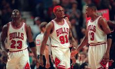 three basketball players standing next to each other in front of an audience at a game