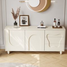 This sideboard is a stylish and functional piece that effortlessly enhances any dining area. It features a sleek, minimalist design with a clean, off - white finish that exudes a sense of modern elegance. The body of the sideboard showcases unique, curved - shaped doors and drawers, adding a touch of artistic flair to its overall appearance. The sideboard provides ample storage space with multiple compartments. The drawers and cabinets are perfect for storing dining essentials such as tableware, Dining Essentials, Kitchen Wine Rack, Dried Plants, Small Space Kitchen, Solid Wood Sideboard, White Sideboard, Chelsea House, Wood Sideboard, Sideboard Furniture