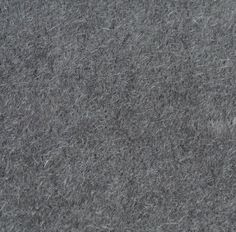 a close up view of the texture of a gray wool material that looks like it has been cut in half