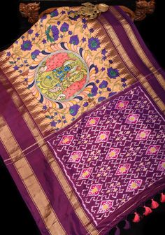 This silk saree showcases stunning Radha Krishna designs, expertly created using the highly desirable Kalamkari technique and incorporating traditional Pichwai elements. The intricate hand-painted motifs in soothing shades of sandle and purple stand out against a backdrop of delicate floral vines. The Ikkat pallu and Stack border add an element of refinement to this magnificent piece, making it a truly exceptional creation. SILK MARK CERTIFIED This saree is ready to wear with fall and pico done. Handmade silk tassels adorn the pallu and add more grace to it. An unstitched blouse fabric is included. *Note: There may be minor variations in the shade, the texture of the product. Hues/textures show differently due to variations in screen settings and other factors, *Note: This is a handwoven s Multicolor Ikat Print Pre-draped Saree For Navratri, Fusion Multicolor Pre-draped Saree With Dupatta, Fusion Style Multicolor Pre-draped Saree With Dupatta, Multicolor Fusion Style Pre-draped Saree With Dupatta, Multicolor Ikat Print Katan Silk Saree, Traditional Silk Dupatta With Ikat Print, Chanderi Dupatta With Ikat Print In Traditional Drape, Chanderi Ikat Print Dupatta In Traditional Drape, Traditional Silk Ikat Print Dupatta