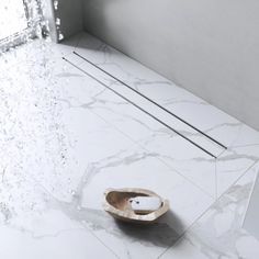 a wooden bowl sitting on top of a white floor next to a window in a room