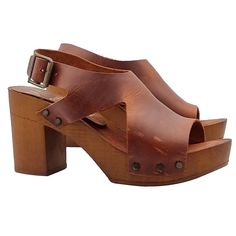 The handcrafted brown heeled sandals are a perfect combination of tradition, high quality and modernity to wear. Versatile and comfortable, they are ideal for all-day wear. Women's clogs with brown wood effect base Upper in brown leather, with two lateral notches Padded insole in leather Adjustable ankle strap 8 cm wide heel + 2.5 cm plateau Stable and light Made entirely by specialized Italian personnel Handcrafted products using the best materials. BEFORE PURCHASING DO NOT FORGET TO CHECK THE Leather High Heel T-strap Sandals, Summer Leather Slingback Sandals With Reinforced Heel, Leather T-strap Sandals With Wooden High Heel, Brown T-strap Sandals With Heel Strap And Open Toe, Summer Open Toe Block Heels With Leather Sole, Brown Open Toe Heels For Summer, Brown High Heel T-strap Sandals With Heel Strap, Brown Leather T-strap Sandals With Block Heel, Chic Brown Slingback Sandals With 4-inch Heel