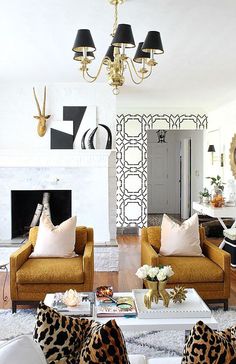 a living room with two couches and a coffee table in front of a fireplace