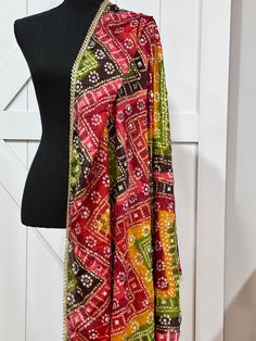 Experience the beauty of traditional Phulkari style with our Multicolor Dupatta. Made with a soft and luxurious silk finish, this dupatta features real mirror accents and stunning designs. Its heavy-weight construction makes it perfect for special occasions like Navaratri. Elevate your wardrobe with this must-have accessory. Approx 2.5 meters length Bohemian Bandhani Print Kurta For Wedding, Bohemian Bandhani Wedding Kurta, Bohemian Bandhani Kurta For Wedding, Bohemian Wedding Kurta With Bandhani Print, Multicolor Silk Kurta With Traditional Drape, Multicolor Silk Kurta For Navratri, Diwali Multicolor Kurta With Sheer Dupatta, Multicolor Kurta With Sheer Dupatta For Diwali, Multicolor Silk Kurta With Cutdana