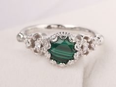 Welcome to my shop, you can find many beautiful gemstone jewelry here, and you also can ask for customized service.  Please notice  malachite is a natural gemstone,each one is similar but not the same Main Stone: Real malachite, round cut 7 mm  Accent Stones: CZ Metal: 925 sterling silver plated with rhodium so as to protect the ring from tarnish and keep it shinning. I also can provide metal options such as 14k solid yellow/white/rose gold Setting: bezel setting  more rings: https://www.etsy.co Malachite Wedding Ring, Elegant Malachite Gemstone Ring, Exquisite Sterling Silver Round Emerald Ring, Exquisite Sterling Silver Emerald Ring, Elegant Silver Malachite Jewelry, Elegant Malachite Ring Jewelry, May Birthstone Jewelry With Intricate Design, Malachite Round Gemstone Jewelry, Round Malachite Gemstone Jewelry