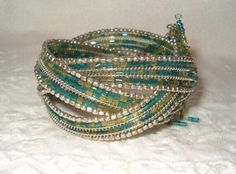 Ethnic Songs!  Turquoise w Yellow Bugle Bead Bracelet, Wire Bangle Bracelet, Silver Beading, 3 Hanging Charm Beads, 1 Missing, very tiny, 1960's. Jewelry, Beaded Bracelets, Bracelets Turquoise Beaded Wrap Bangle Bracelet, Green Bohemian Beaded Bracelets With Silver Beads, Green Wrap Bracelet With Round Beads For Festival, Green Beaded Wrap Bracelet For Festival, Bohemian Green Beads, Bugle Bead Bracelet, Wire Bangle Bracelets, Wire Bangles, Charm Beads