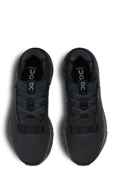 a pair of black shoes with white lettering on the soles and side laces