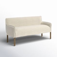 a white couch sitting on top of a wooden frame