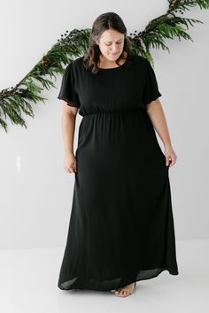 The modest formal maxi dress that you have been waiting for! The ‘Naomi’ is effortless and feminine - the perfect pick for family photos, an elegant party, or a modest bridesmaid dress. This timeless dress features a modest scoop neckline, flutter sleeves, and a chiffon overlay. The lightly gathered elastic waist and zipper closure allow for ease of styling and a flattering fit. This dress is fully lined - no layering required! Exclusively designed with you in mind. Self & Lining 100% Polyester Modest Chiffon Maxi Dress, Modest Flowy Floor-length Maxi Dress, Flowy Modest Floor-length Maxi Dress, Modest Floor-length Maxi Dress For Evening, Modest Solid Color Maxi Dress For Evening, Modest Floor-length Maxi Dress For Formal Occasions, Modest Black Maxi Dress For Formal Occasions, Modest Maxi Dress For Evening, Modest Evening Maxi Dress