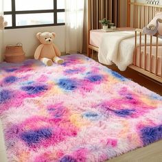 a child's room with a teddy bear on the floor and a rug in the middle