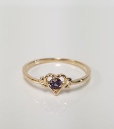 "Thanks for shopping our vintage estate store. We tend to sell well below wholesale and truly hope you enjoy all of our items. Many of the items are one of a kind, so please enjoy scrolling through the pictures and hopefully something will catch your eye. Spots are from reflections or camera. Estate 14k yellow gold created .10ct alexandrite heart ring. The color of the gem is blue, green, to purple. No scratches on the gem. Stunning. Bought out a jewelry store that was closing and these were lef Classic 14k Gold Heart-shaped Birthstone Ring, Vintage Gold Heart Ring With Birthstone, Vintage Gold Amethyst Birthstone Ring, Yellow Gold Heart-shaped Formal Birthstone Ring, Yellow Gold Heart-shaped Birthstone Ring For Formal Occasions, Heart-shaped Yellow Gold Birthstone Ring For Formal Occasions, Gold Heart-shaped Birthstone Ring For Formal Events, Gold Heart-shaped Birthstone Ring For Formal Occasions, Classic Heart Ring With Birthstone For Valentine's Day