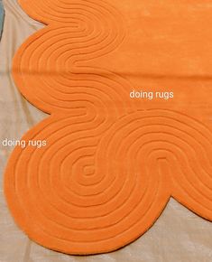 an orange rug with the words doing rugs on it