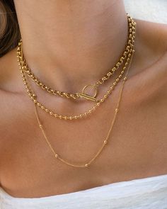 Our best-selling Olivia Necklace is a staple you need to elevate any look. It's a Double Layer Gold Plated Stainless Steel Ball Chain Necklace. Can be worn alone or paired with our Hailey Choker as seen. Classic Gold Lariat Necklace With Clavicle Chain, Gold Clavicle Chain Link Necklace, Gold Round Chain Necklace With Adjustable Chain, Gold Clavicle Chain Link Charm Necklaces, Gold Link Clavicle Charm Necklace, Gold Plated Tarnish Resistant Link Necklace, Dainty Lariat Necklace Tarnish Resistant, Dainty Tarnish Resistant Lariat Necklace, Dainty Tarnish-resistant Lariat Necklace