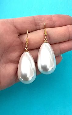 Large, faux pearl teardrop earrings from Olivia Divine. Shiney, white faux pearl, drop style earrings. Pierced, lightweight. Gold tone, hook style ear wire. Length 3.8 cm approx. Handmade design. Perfect for wedding, brides and bridesmaids. Pearl White Teardrop Bridal Earrings For Party, White Teardrop Pearl Earrings For Party, White Drop Pearl Earrings For Party, White Pear-shaped Bridal Earrings For Party, Pear-shaped White Bridal Earrings For Party, White Teardrop Earrings With Pearl Charm For Formal Occasions, White Drop Teardrop Earrings For Party, White Teardrop Earrings For Party, Party Teardrop Pearl Earrings