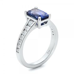 Custom Blue Sapphire and Diamond Engagement Ring Channel Set Sapphire Rings With Emerald Cut, Channel Set Emerald Cut Sapphire Rings, Blue Emerald Ring With Accent Stones For Anniversary, Blue Emerald Ring With Prong Setting, Blue Emerald Classic Promise Ring, Classic Blue Emerald Ring With Accent Stones, Blue Tanzanite Emerald Cut Ring, Blue Rings With Side Stones And Round Cut, Emerald Cut Sapphire Channel Set Rings