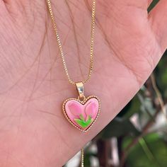 Trendy Pink tulip flower heart shaped pendant charm necklace, 14K real gold plated chain. Crafted from high-quality materials, this stunning necklace features a delicate heart-shaped pendant adorned with a beautiful pink tulip motif, symbolizing love, beauty, and new beginnings. Cute girly aesthetic, y2k layering necklace choker. Exquisite statement necklace to elevate your fashion style. 💎 Features: ♥ Handmade jewelry ♥ Finish Tone: Finest 14K gold plated | Pink ♥ Approximate Measurements: - L Pink Flower Charm Necklace With Flower Pendant, Pink Pendant Charm Necklace, Pink Flower Charm Necklace Gift, Pink Flower Charm Necklaces For Gift, Pink Flower Charm Necklaces As Gift, Pink Flower Pendant Necklace For Valentine's Day, Pink Flower Pendant Necklace With Clavicle Chain, Pink Flower Pendant Clavicle Necklace, Pink Clavicle Chain Necklace For Valentine's Day