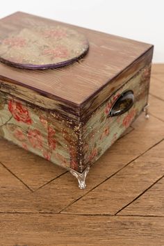 a wooden box sitting on top of a hard wood floor