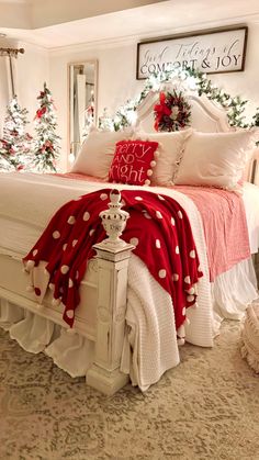 a bedroom decorated for christmas with red and white decor