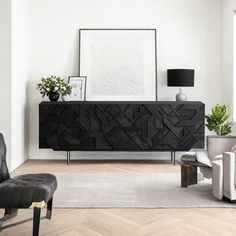 a living room with white walls and black furniture