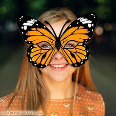 a girl with a butterfly mask on her face