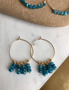 Elegant Blue Apetite Stones beaded and dangle in either choice of silver plated hoops, sterling silver hoops, gold plated hoops, or 14k gold filled hoops. Perfect bohemian jewelry, perfect size and dangle. Super gorgeous with boho outfits. Light and comfortable. Make a statement today! 💜Simple, Dainty and Elegant Raw Natural Stones for everyday wear that's lasting. Simple yet elegant especially the shine and color are so gorgeous.The picture does not do it justice it and is much prettier in per Blue Small Hoop Jewelry With Dangling Beads, Blue Small Hoop Earrings With Dangling Beads, Blue Bohemian Hoop Earrings With Natural Stones, Bohemian Blue Hoop Earrings With Natural Stones, Handmade Blue Apatite Earrings, Blue Natural Stone Dangle Hoop Earrings, Blue Hoop Earrings With Natural Stones, Blue Hoop Jewelry With Natural Stones, Blue Natural Stone Hoop Jewelry