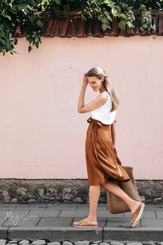 "Knee-length wrap linen skirt with a higher waistline. This midi linen skirt fastens with a crossover front, super easy to slip in and slip out. The A-line silhouette and lightweight linen fabric ensure elegance and comfort all year round. Available in cinnamon Please note that due to the many variations in monitors and browsers, actual colors may vary. DETAILS * Model wearing Cinnamon in size S is 5'10\" (178 cm) * Made from 100% European linen * Stone washed for maximum softness * OEKO-TEX cer Linen Wrap Skirt, Linen Shawl, Wrinkled Clothes, Wrap Clothing, Linen Tank Top, Linen Tank, Skirt Midi, Dark Wear, Linen Skirt