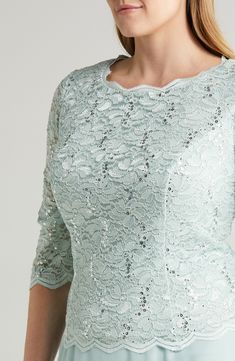 Scalloped stretch lace alight in sequins layers the bodice of this formal dress with a flowing chiffon skirt that gives the illusion of coordinated separates. 47" length (size 18W) Hidden back-zip closure Bateau neck Elbow-length sleeves Bra friendly Lined, except sleeves 58% nylon, 40% polyester, 2% spandex with 100% polyester contrast Hand wash, dry flat Imported Women's Clothing Holiday Formal Lace Dresses, Formal Holiday Lace Dresses, Elegant Lace Sequin Dress For Prom, Holiday Lace Evening Dress For Formal Occasions, Elegant Lace Sequin Dress For Gala, Formal Holiday Lace Evening Dress, Elegant Lace Sequin Wedding Dress, Elegant Lace Mother Of The Bride Dress With Sequins, Elegant Spring Lace Sequin Dress