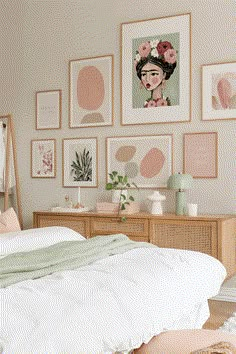 a bedroom with pictures on the wall above the bed