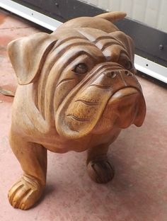 a wooden statue of a dog on the ground