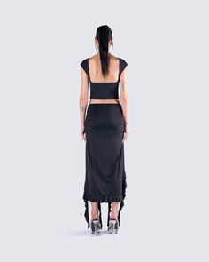 Let your sultry side shine in this sexy all-black fit 🖤 Featuring a black backless top, paired with a black ruffled maxi skirt for a look that will have you turning heads and taking names 🤤 Fitted Ruffled Crop Top For Evening, Flirty Ruffled Crop Top For Night Out, Chic Ruffled Maxi Skirt For Evening, Elegant Ruffled Crop Top For Party, Chic Black Maxi Skirt For Club, Black Fitted Maxi Skirt For Club, Fitted Black Maxi Skirt For Club, Evening Stretch Maxi Skirt For Summer, Summer Evening Stretch Maxi Skirt