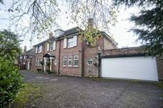 a large brick house with two garages